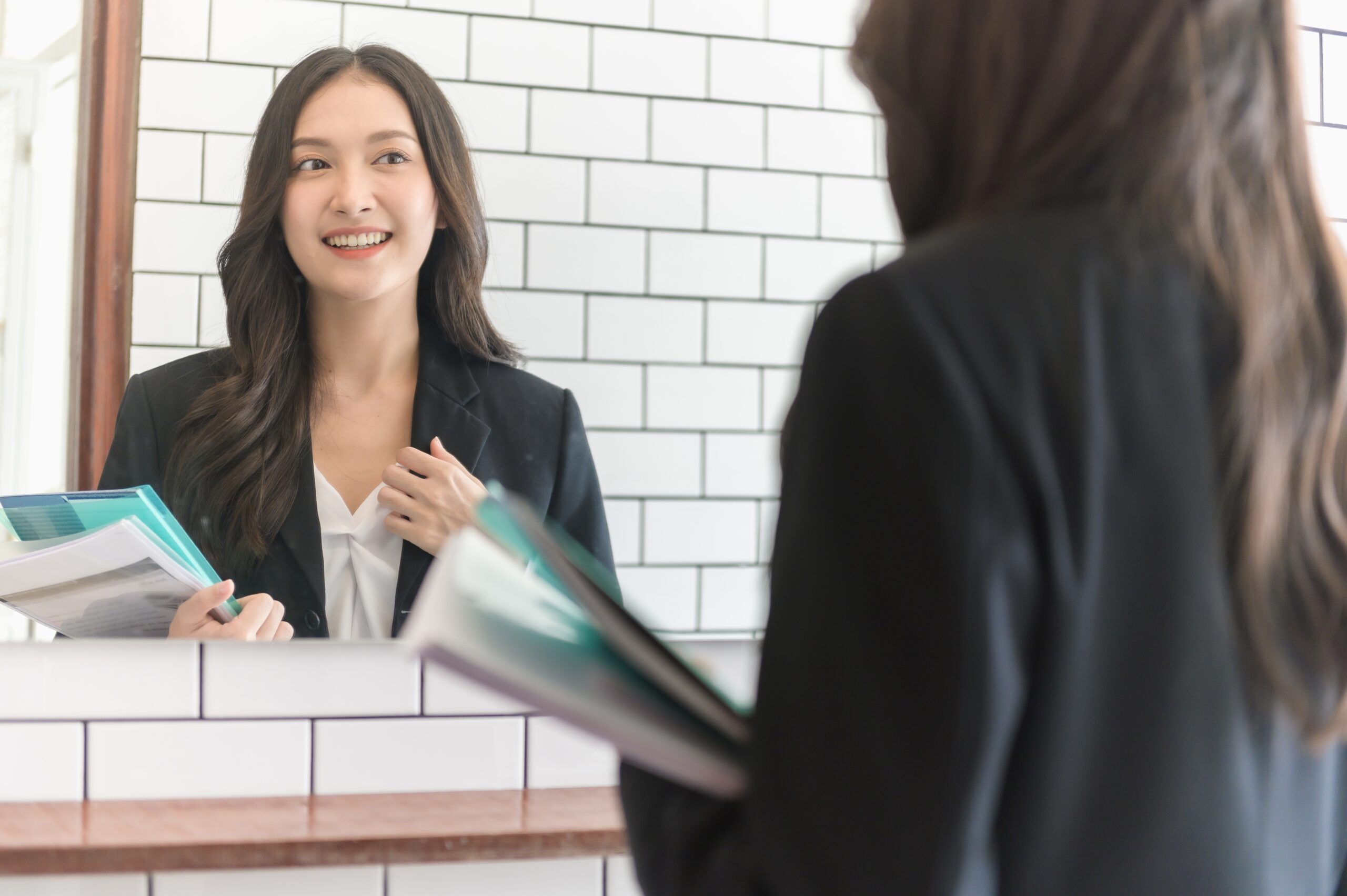 Sales rep practicing sales techniques in front of the mirror.